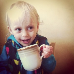 kid posing with coffee cup